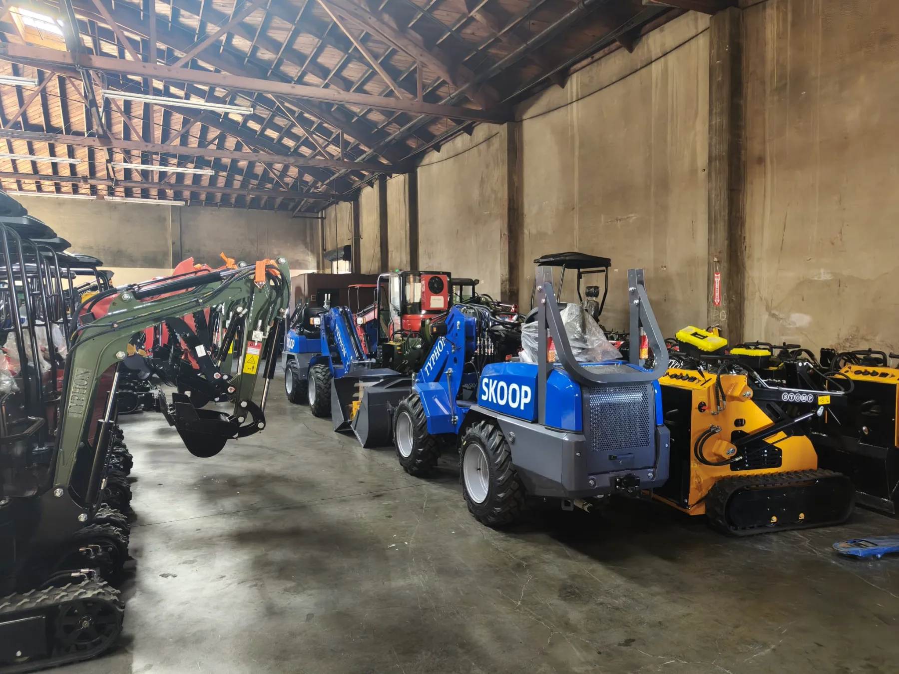 Warehouse equipment inventory showing organized fleet of compact machinery