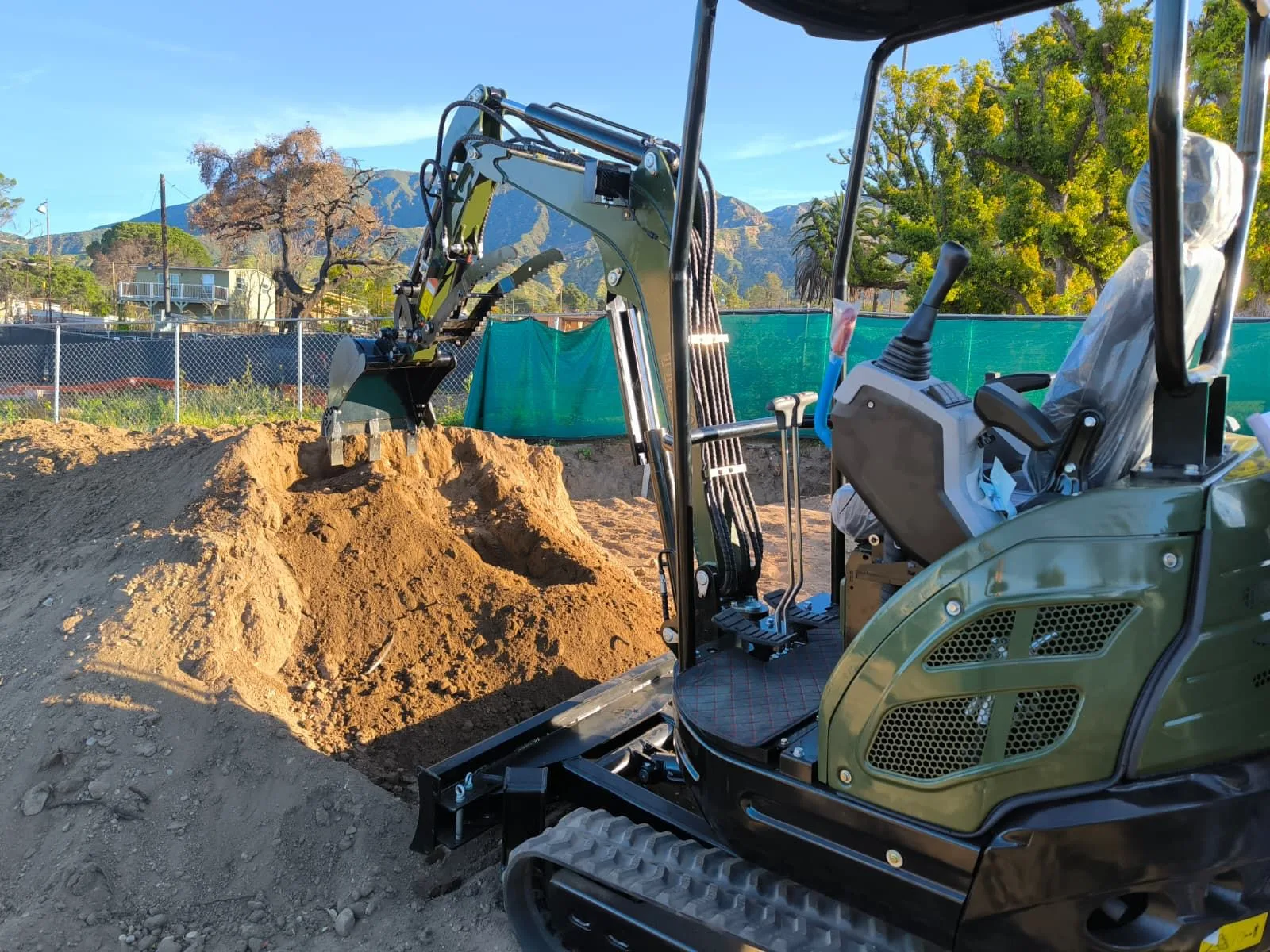 Equipment storage showing excavator cabs, booms, and tracks staged for freight